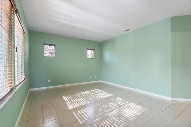 a spacious bathroom with a double vanity sink a large mirror and shower