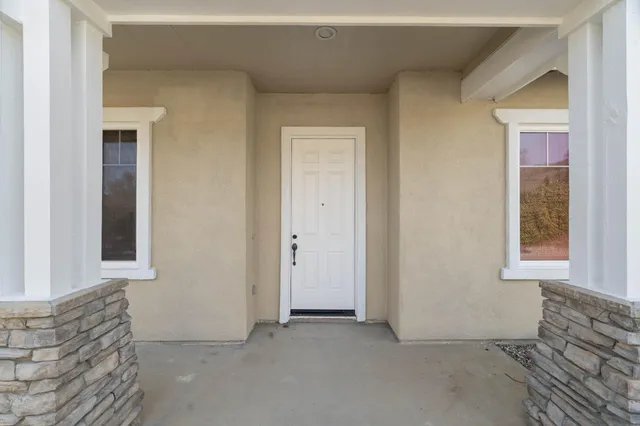 a view of an empty room with windows