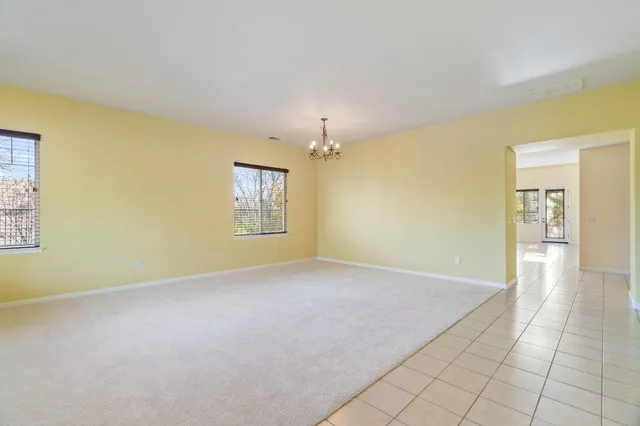 an empty room with a empty space and windows