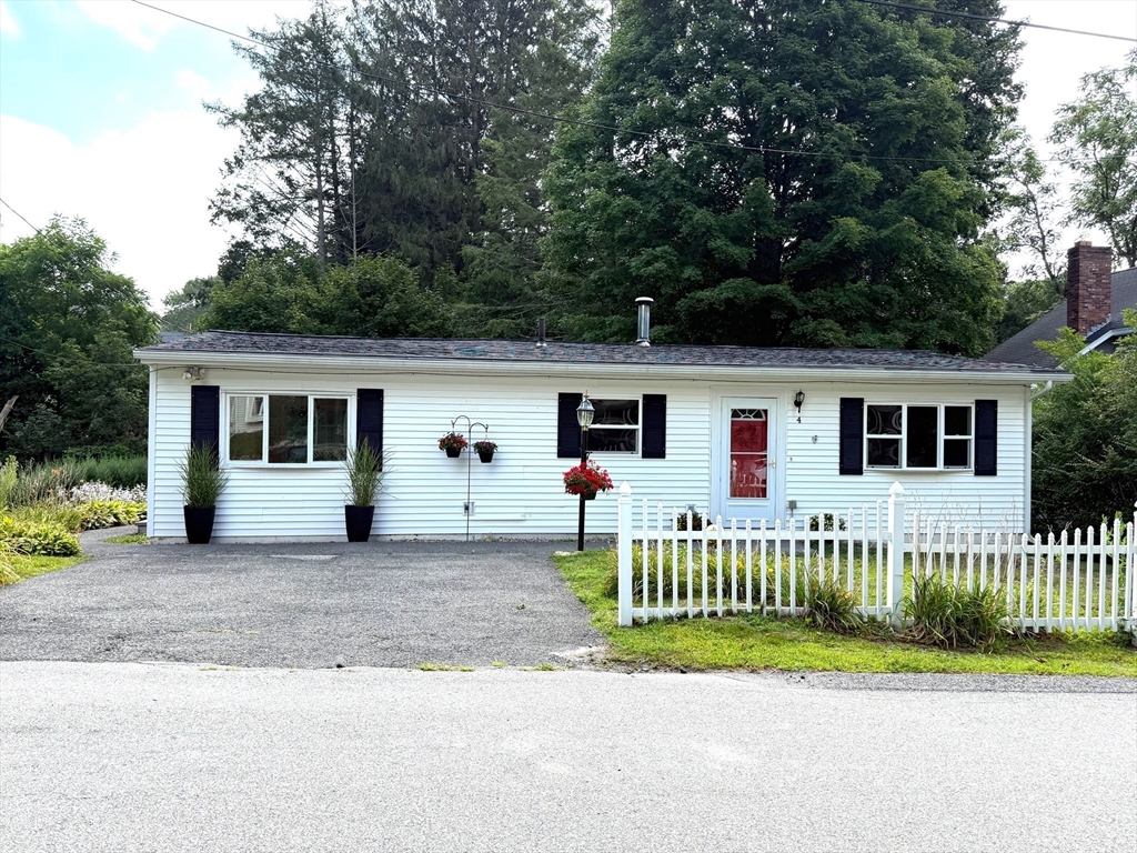 4 Depot Street Upton, MA 01568 - Photo 3 of 26 a front view of a house with a garden