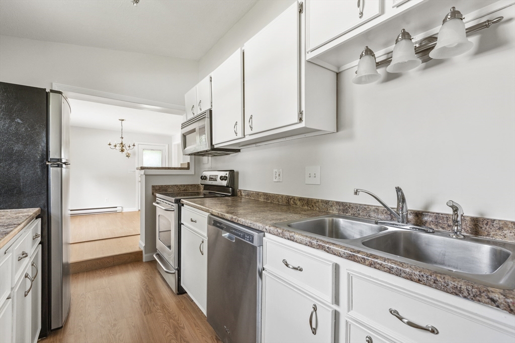 4 Depot Street Upton, MA 01568 - Photo 7 of 26 a kitchen with stainless steel appliances granite countertop a sink stove and refrigerator