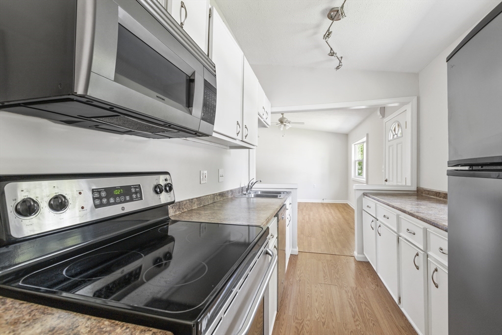 4 Depot Street Upton, MA 01568 - Photo 8 of 26 a kitchen with stainless steel appliances granite countertop a stove and a microwave