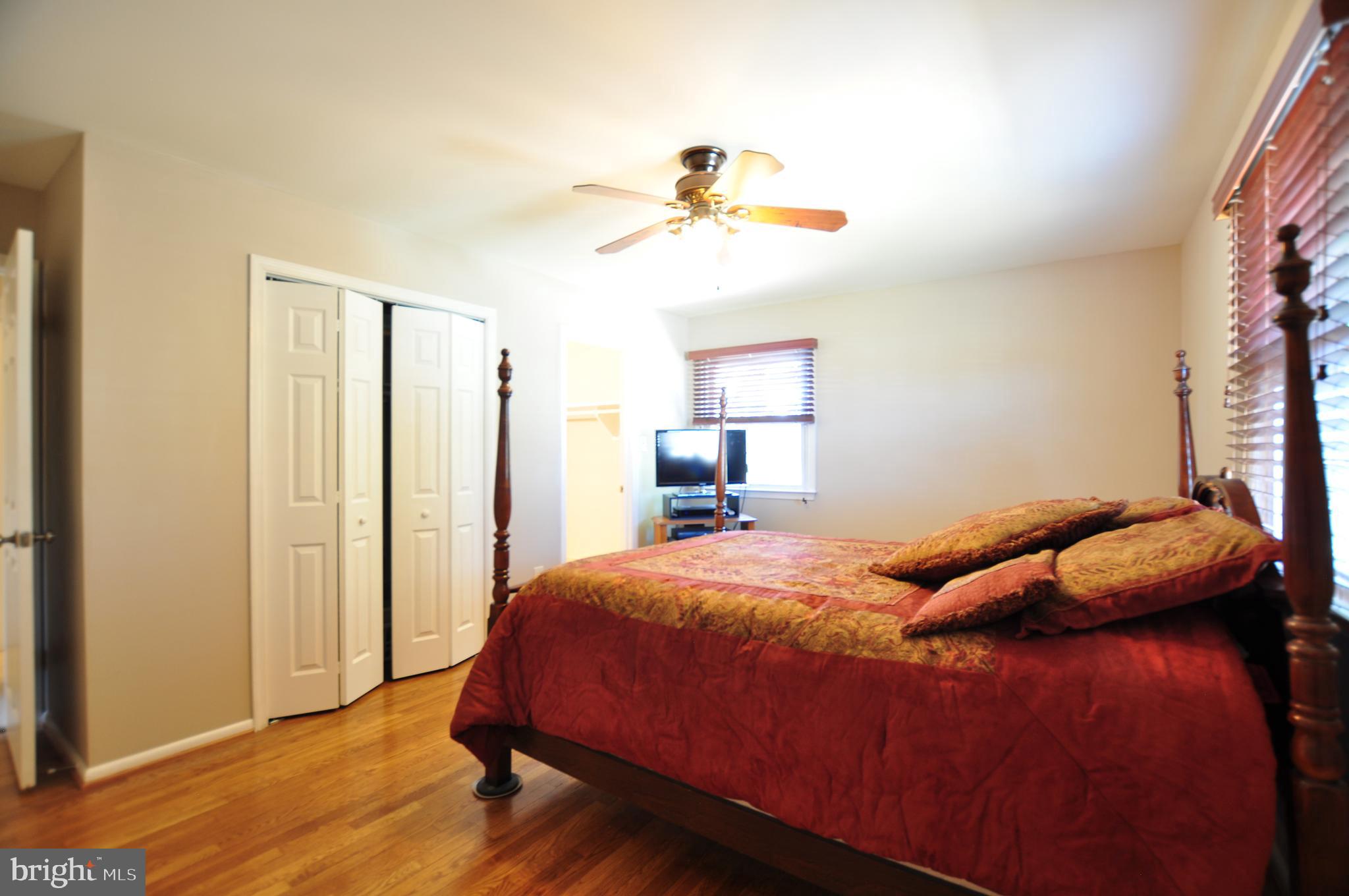 19412 Olney Mill Road Olney, MD 20832 - Photo 22 of 60 a bedroom with a bed and wooden floor