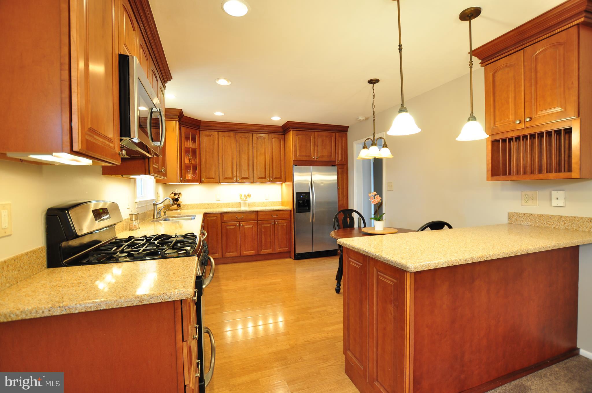 19412 Olney Mill Road Olney, MD 20832 - Photo 8 of 60 a kitchen with a sink a counter top space a stove and a refrigerator