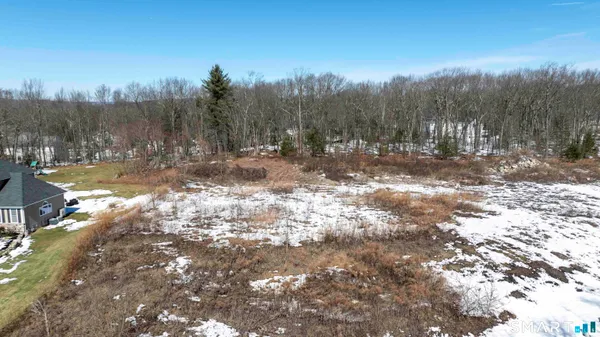 a view of a yard with wooden fence