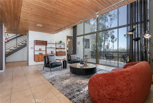 a sitting area with furniture and wooden floor