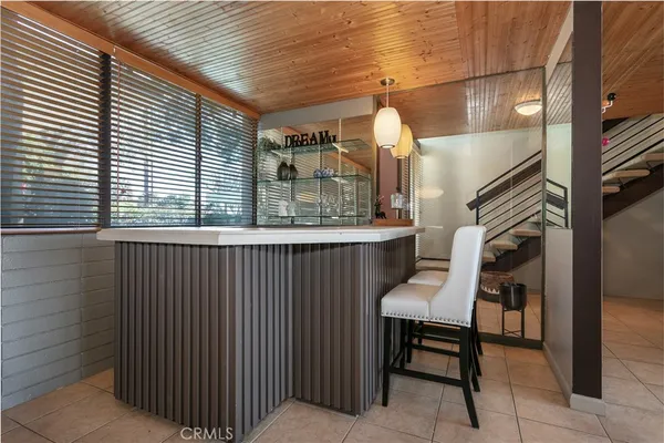 a kitchen with granite countertop a stove a sink and a microwave