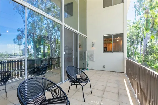 a bedroom with a bed a couch and a chandelier