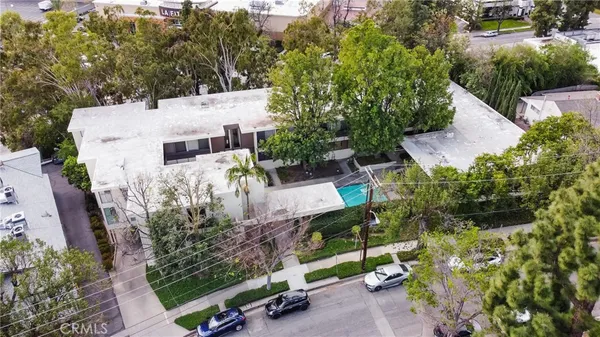 an aerial view of a house with a yard basket ball court and outdoor seating