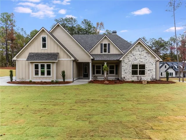 a front view of a house with a garden