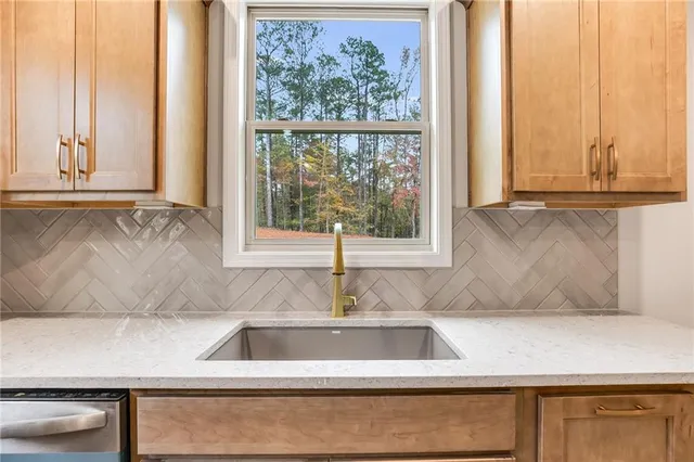 a kitchen with a sink and a window