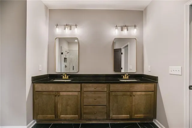 a bathroom with sinks and mirror