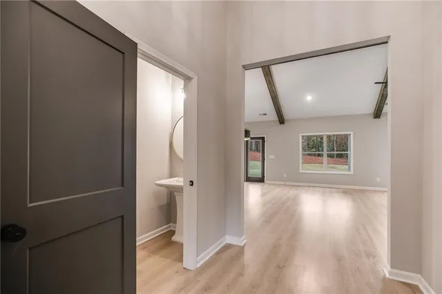 an empty room with wooden floor and a window