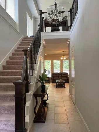 a view of entryway and hall with wooden floor