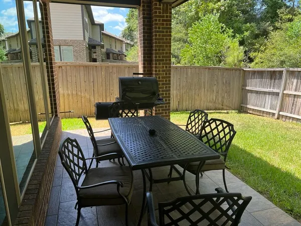 a view of a patio with couple of chairs