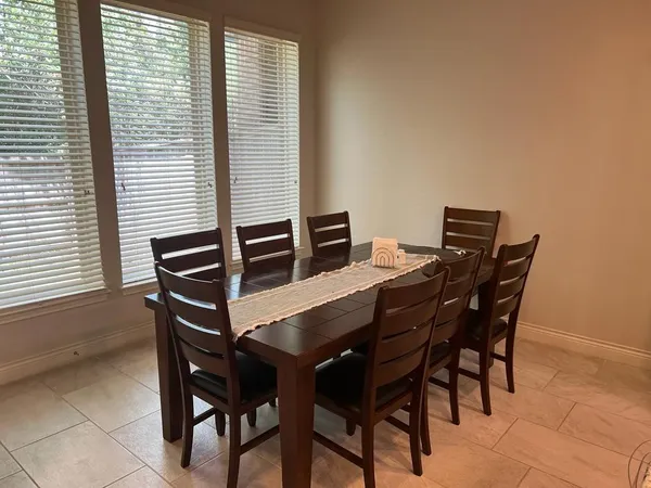 a view of a dining room with furniture and window