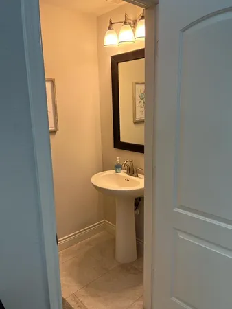 a bathroom with a sink a mirror and a toilet