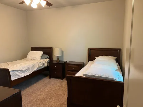 a bedroom with a bed and a chandelier