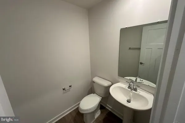 a bathroom with a sink toilet and a mirror