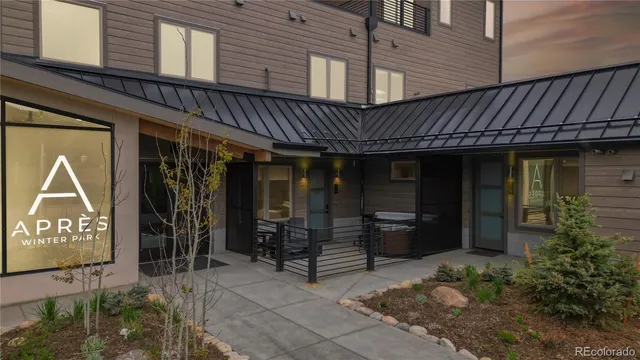 a kitchen with a sink a stove cabinets and living room view