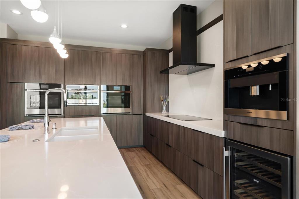 16047 Redington Drive Redington Beach, FL 33708 - Photo 18 of 80 a kitchen with stainless steel appliances kitchen island granite countertop a refrigerator and a stove top oven