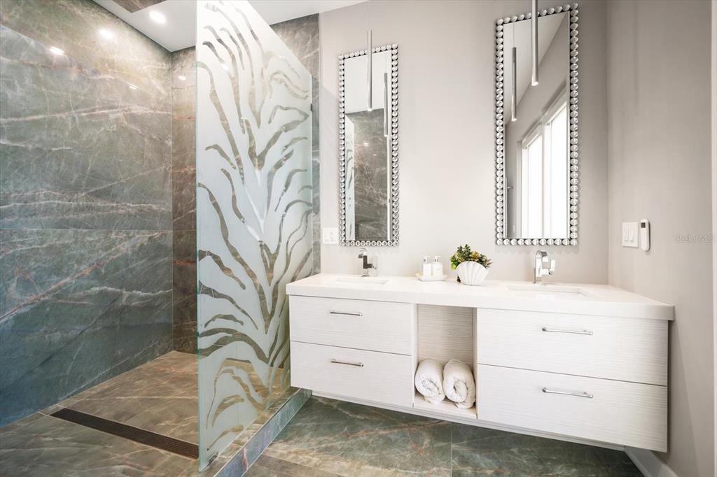 16047 Redington Drive Redington Beach, FL 33708 - Photo 25 of 80 a bathroom with a sink mirror and a shower