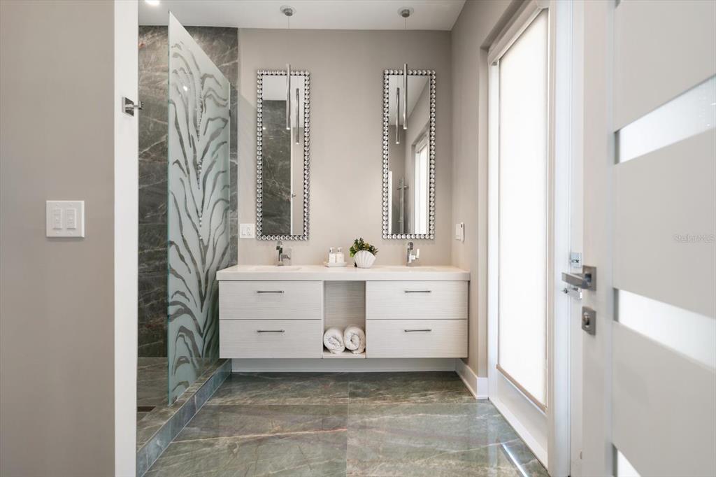 16047 Redington Drive Redington Beach, FL 33708 - Photo 27 of 80 a bathroom with a sink a mirror and a bathtub