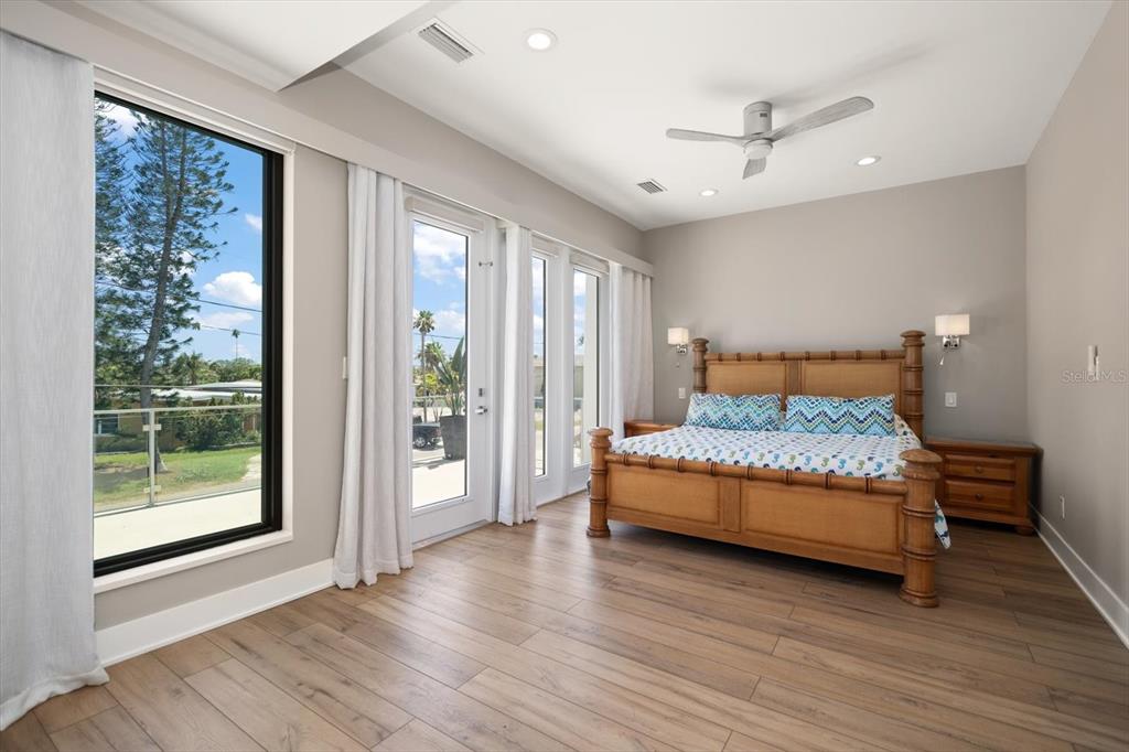 16047 Redington Drive Redington Beach, FL 33708 - Photo 28 of 80 a bedroom with a bed and wooden floor