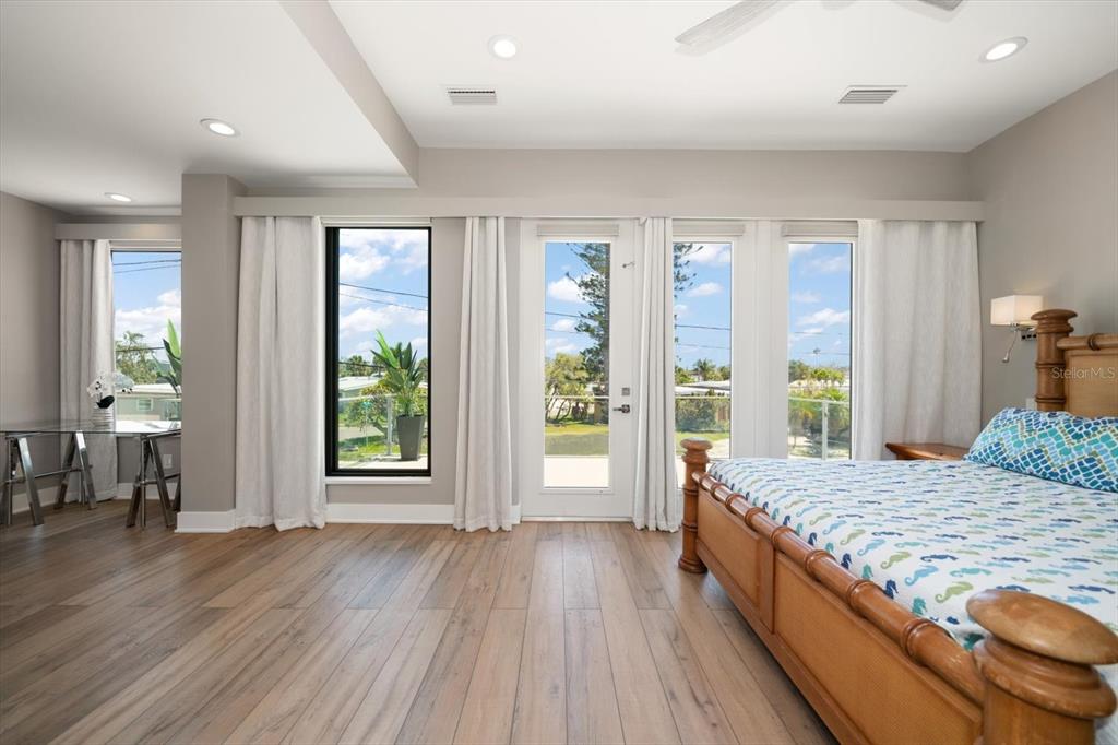 16047 Redington Drive Redington Beach, FL 33708 - Photo 29 of 80 a spacious bedroom with a large bed and a large window