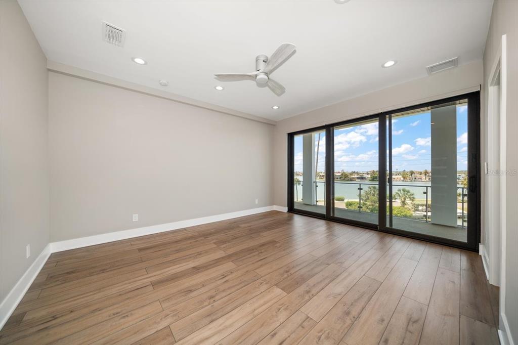 16047 Redington Drive Redington Beach, FL 33708 - Photo 42 of 80 a view of an empty room with wooden floor and a window