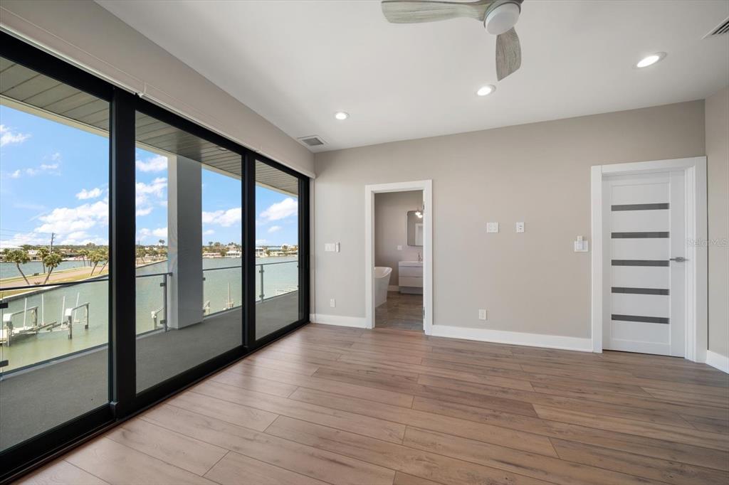 16047 Redington Drive Redington Beach, FL 33708 - Photo 43 of 80 a view of empty room with wooden floor and fan