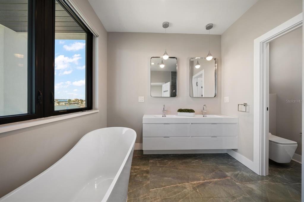 16047 Redington Drive Redington Beach, FL 33708 - Photo 46 of 80 a bathroom with a bathtub sink and mirror