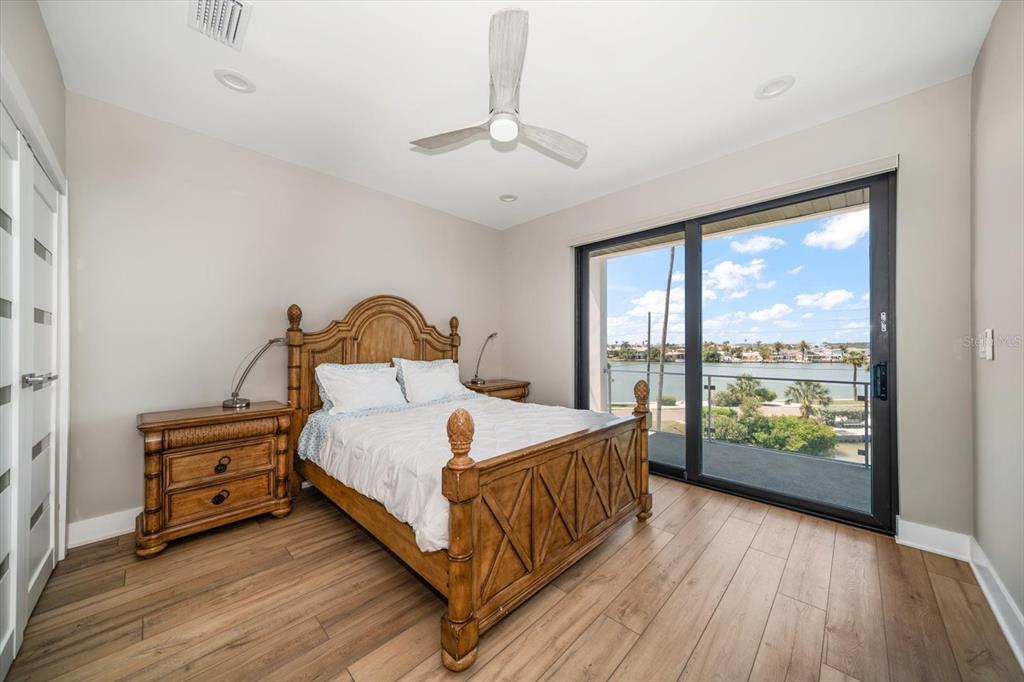 16047 Redington Drive Redington Beach, FL 33708 - Photo 52 of 80 a bedroom with a bed and a large window