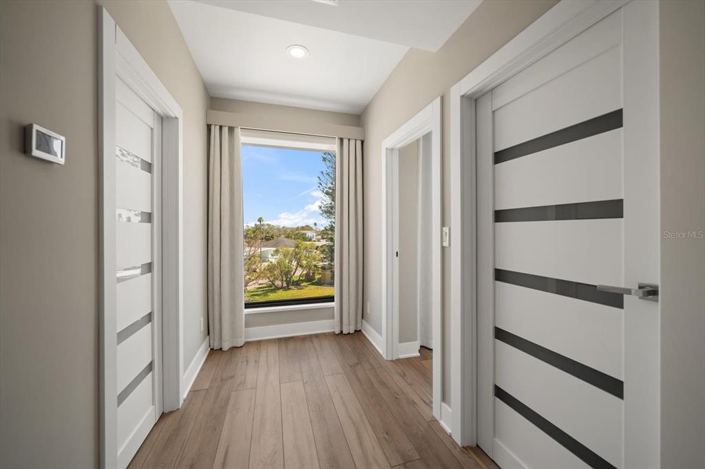 16047 Redington Drive Redington Beach, FL 33708 - Photo 55 of 80 a view of an empty room with wooden floor and a window