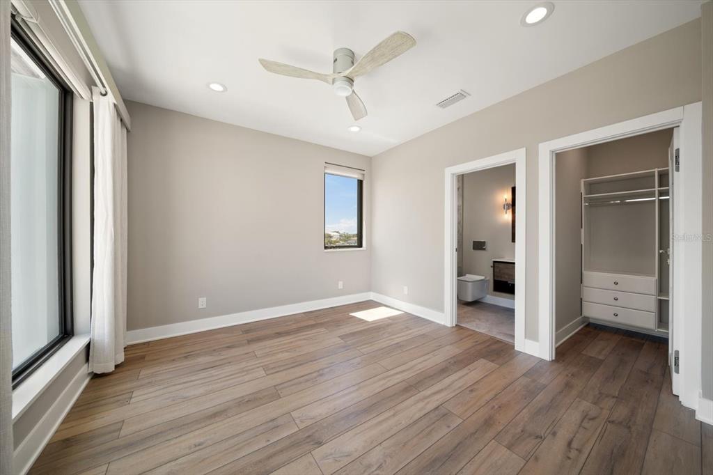 16047 Redington Drive Redington Beach, FL 33708 - Photo 57 of 80 wooden floor in an empty room with a window
