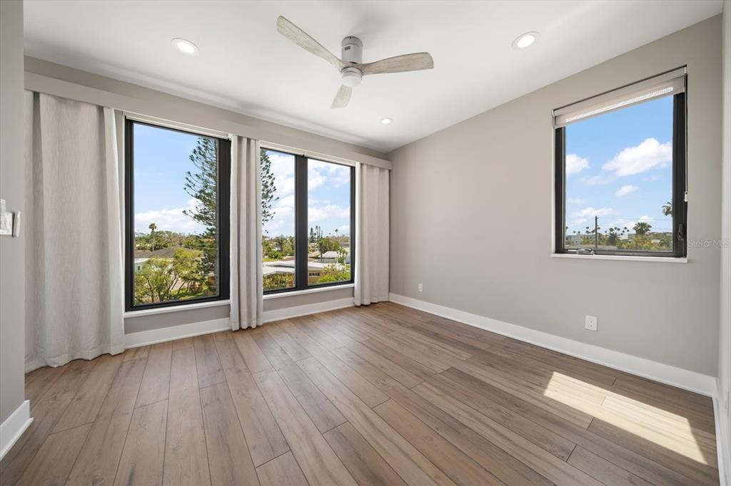 16047 Redington Drive Redington Beach, FL 33708 - Photo 58 of 80 wooden floor in an empty room with a window