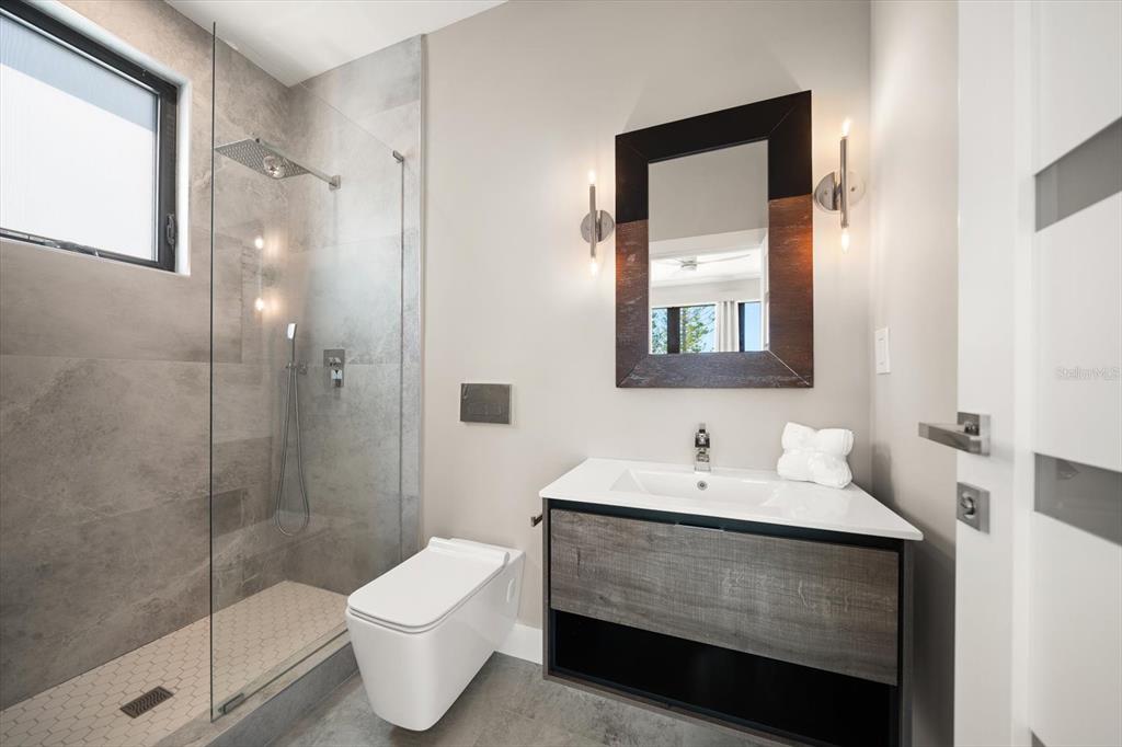 16047 Redington Drive Redington Beach, FL 33708 - Photo 59 of 80 a bathroom with a sink and a mirror