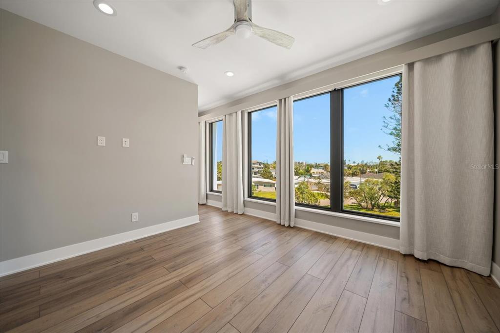 16047 Redington Drive Redington Beach, FL 33708 - Photo 61 of 80 an empty room with wooden floor and windows