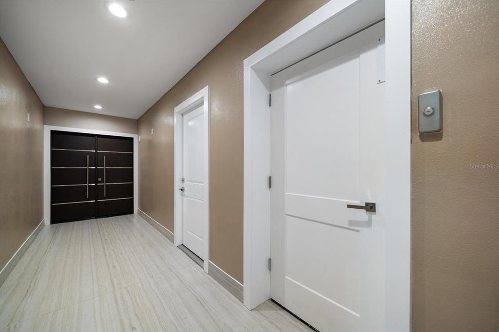 16047 Redington Drive Redington Beach, FL 33708 - Photo 65 of 80 a view of an empty room with wooden floor and a window