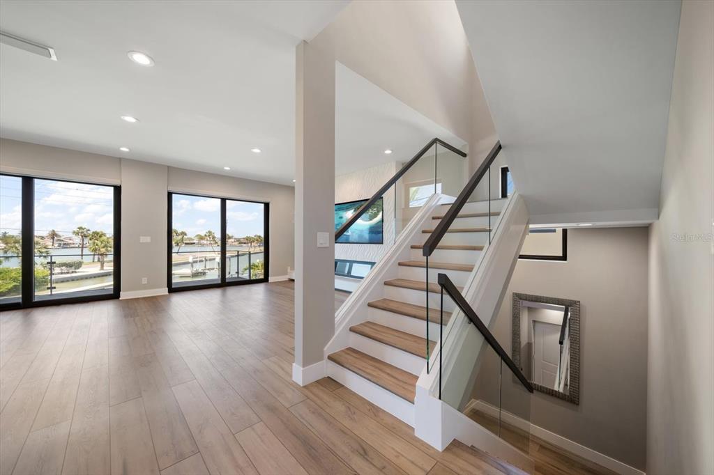 16047 Redington Drive Redington Beach, FL 33708 - Photo 7 of 80 a view of an entryway with wooden floor door and windows