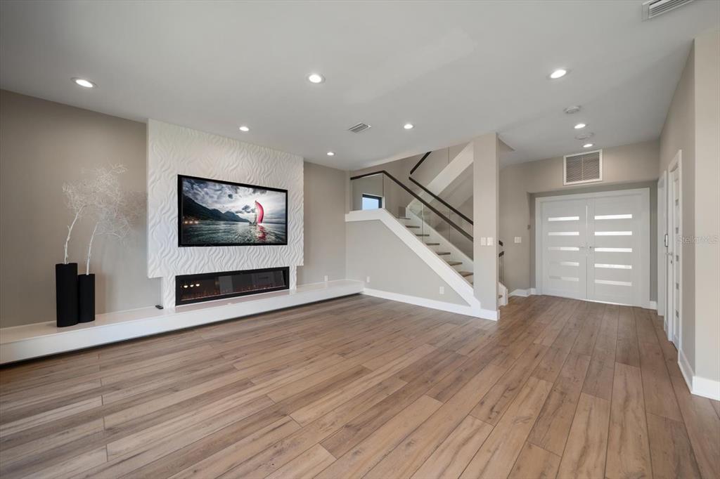 16047 Redington Drive Redington Beach, FL 33708 - Photo 8 of 80 a view of an empty room with wooden floor and staircase
