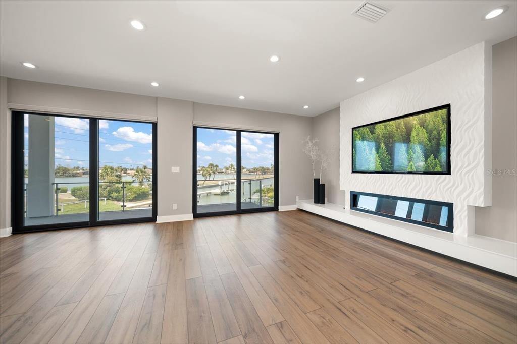 16047 Redington Drive Redington Beach, FL 33708 - Photo 9 of 80 an empty room with wooden floor and windows