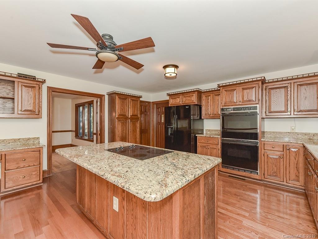 402 3 Knotts Road Monroe, NC 28112 - Photo 11 of 48 a kitchen with kitchen island sink refrigerator and cabinets