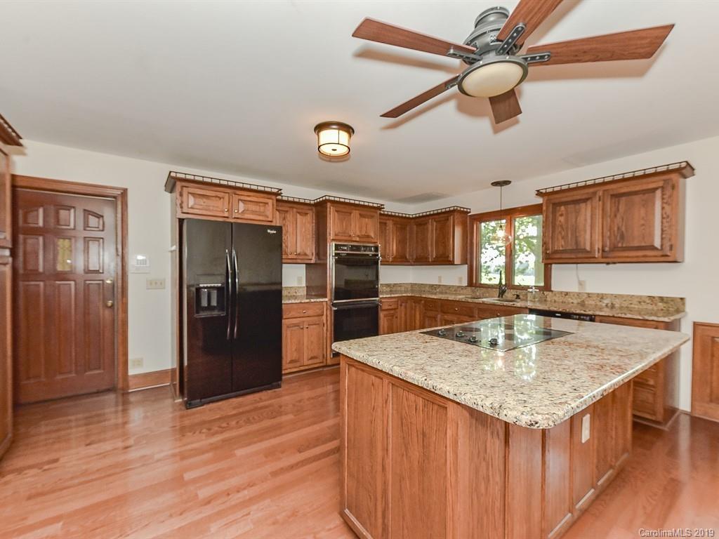 402 3 Knotts Road Monroe, NC 28112 - Photo 12 of 48 a kitchen with stainless steel appliances granite countertop a sink a refrigerator and a stove