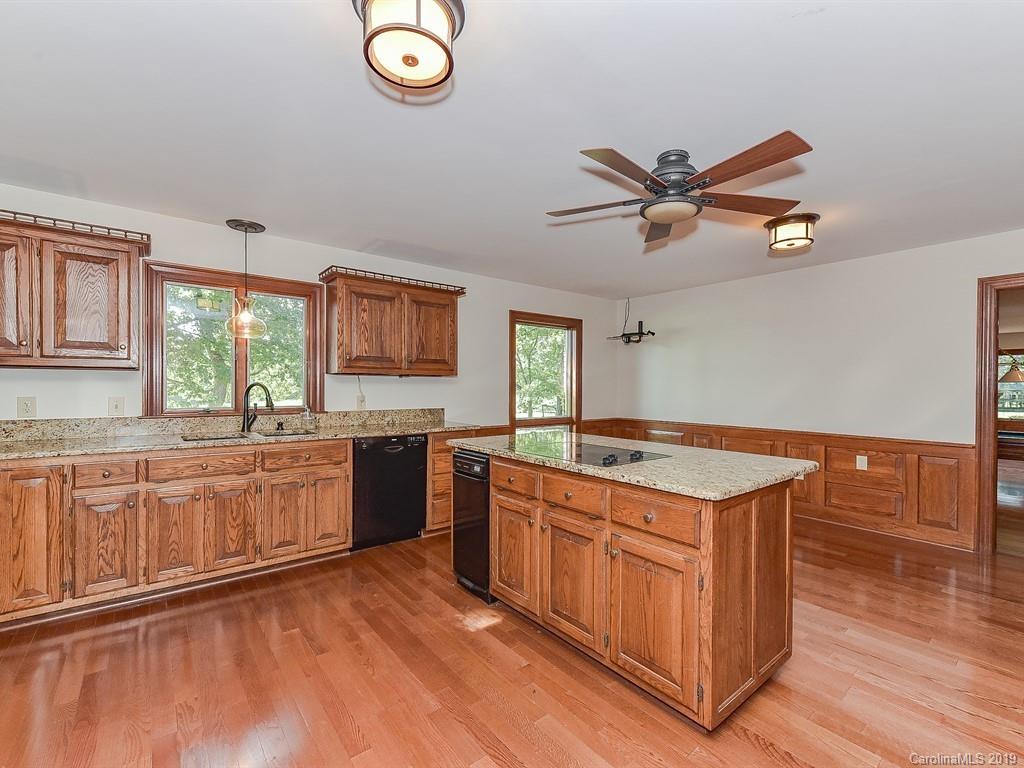 402 3 Knotts Road Monroe, NC 28112 - Photo 14 of 48 a kitchen with granite countertop a stove a sink and a refrigerator