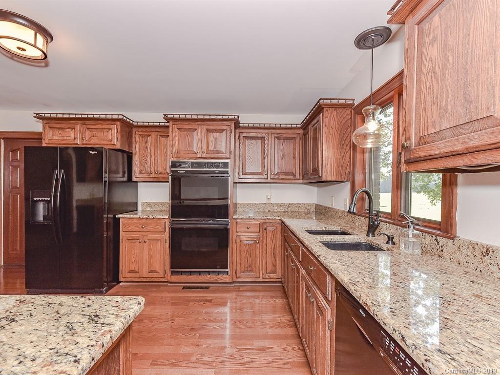 402 3 Knotts Road Monroe, NC 28112 - Photo 16 of 48 a kitchen with stainless steel appliances granite countertop a sink stove and refrigerator