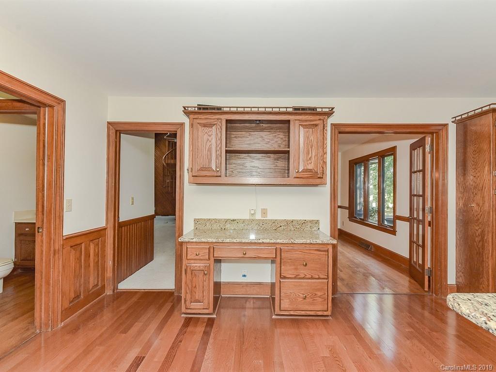 402 3 Knotts Road Monroe, NC 28112 - Photo 17 of 48 a kitchen with granite countertop a stove and wooden floor