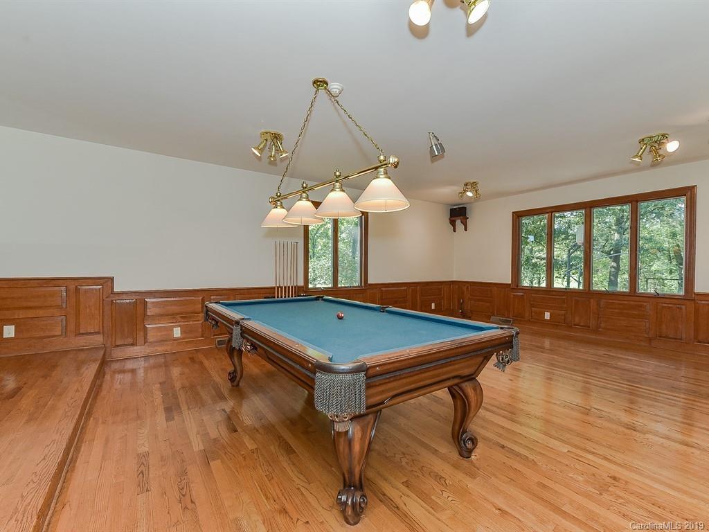 402 3 Knotts Road Monroe, NC 28112 - Photo 21 of 48 a room with wooden floor pool table and windows