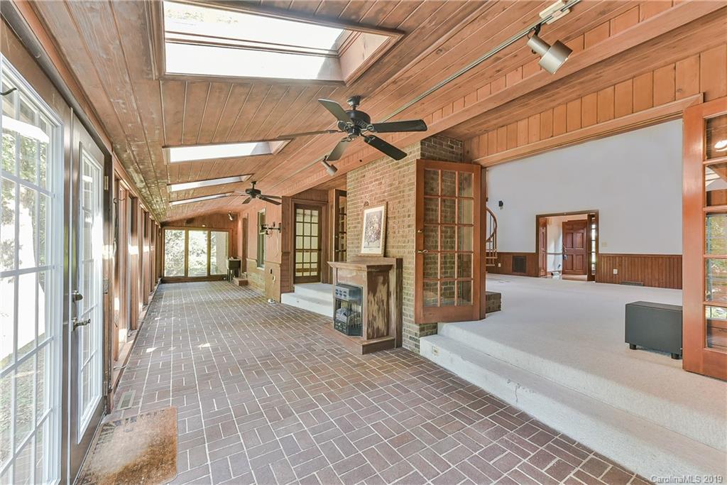 402 3 Knotts Road Monroe, NC 28112 - Photo 26 of 48 a view of a hall with wooden floor and floor to ceiling window