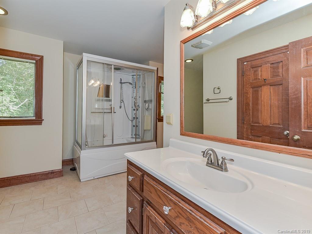 402 3 Knotts Road Monroe, NC 28112 - Photo 31 of 48 a bathroom with a granite countertop sink and a mirror